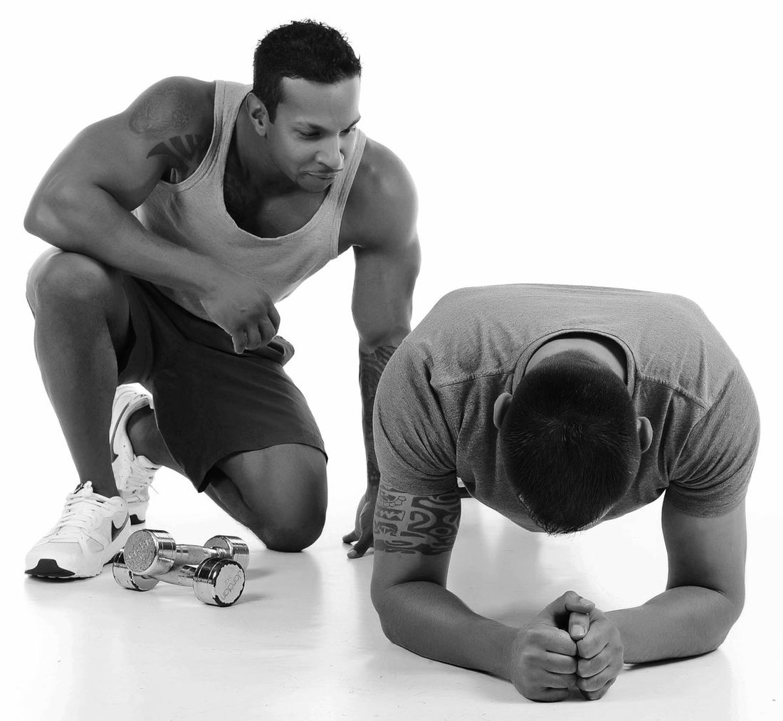 Coach guiding an athlete through a workout