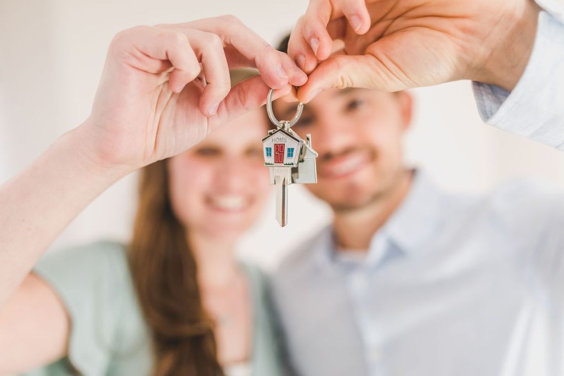 New homeowners holding their keys